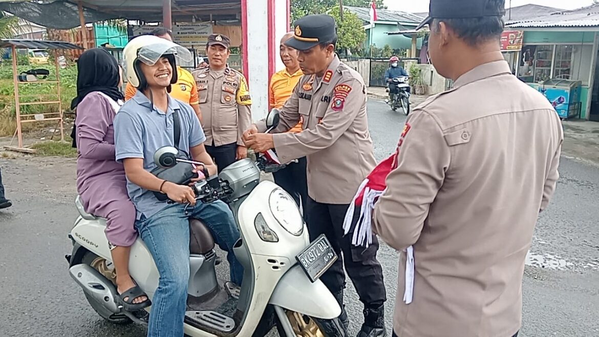 Gelorakan HUT RI Ke-80, Kapolsek Indrapura AKP Reynold Silalahi, S.H Bagikan Bendera Merah Putih